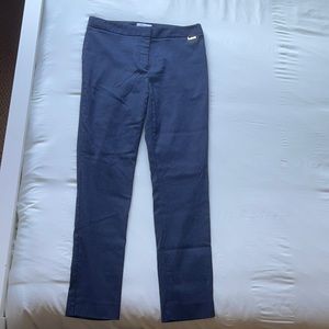 Calvin Klein navy and white pinstripe trousers.